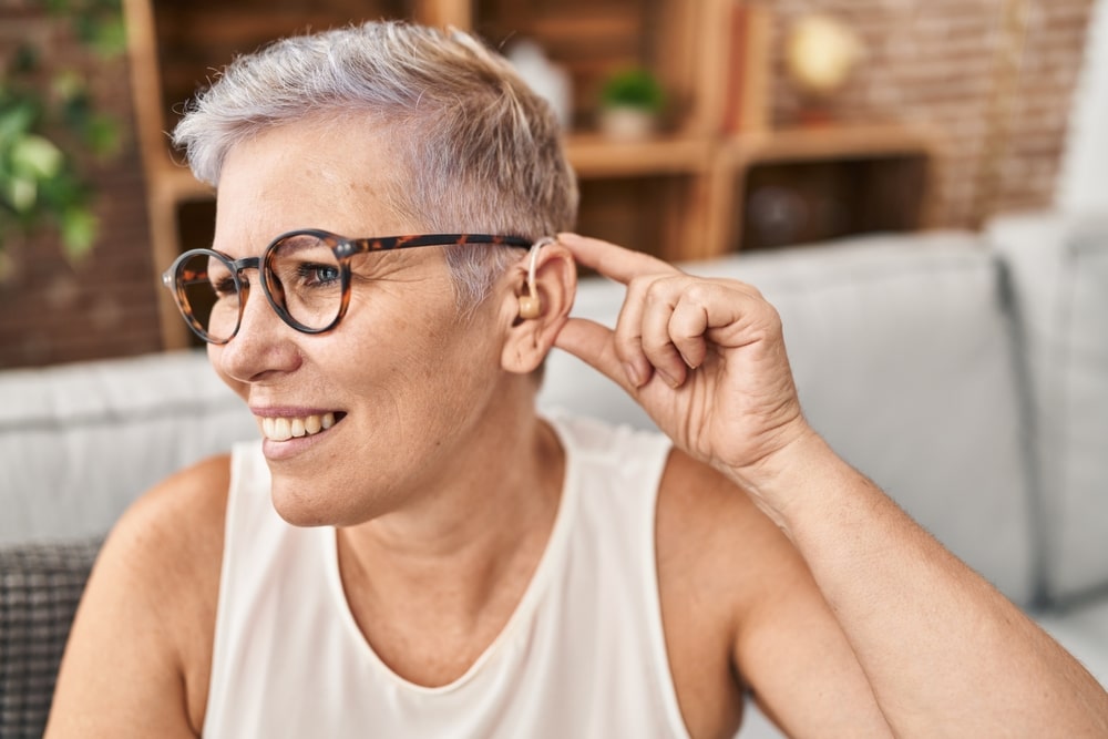 Woman with glasses and hearing aid